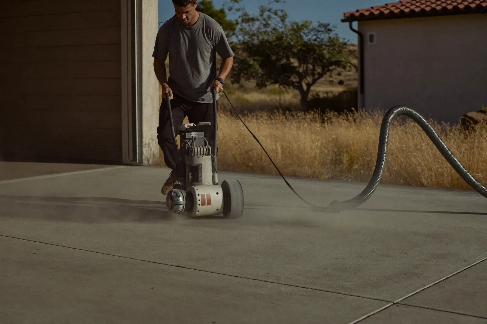 Walk-behind diamond grinder opening a concrete slab