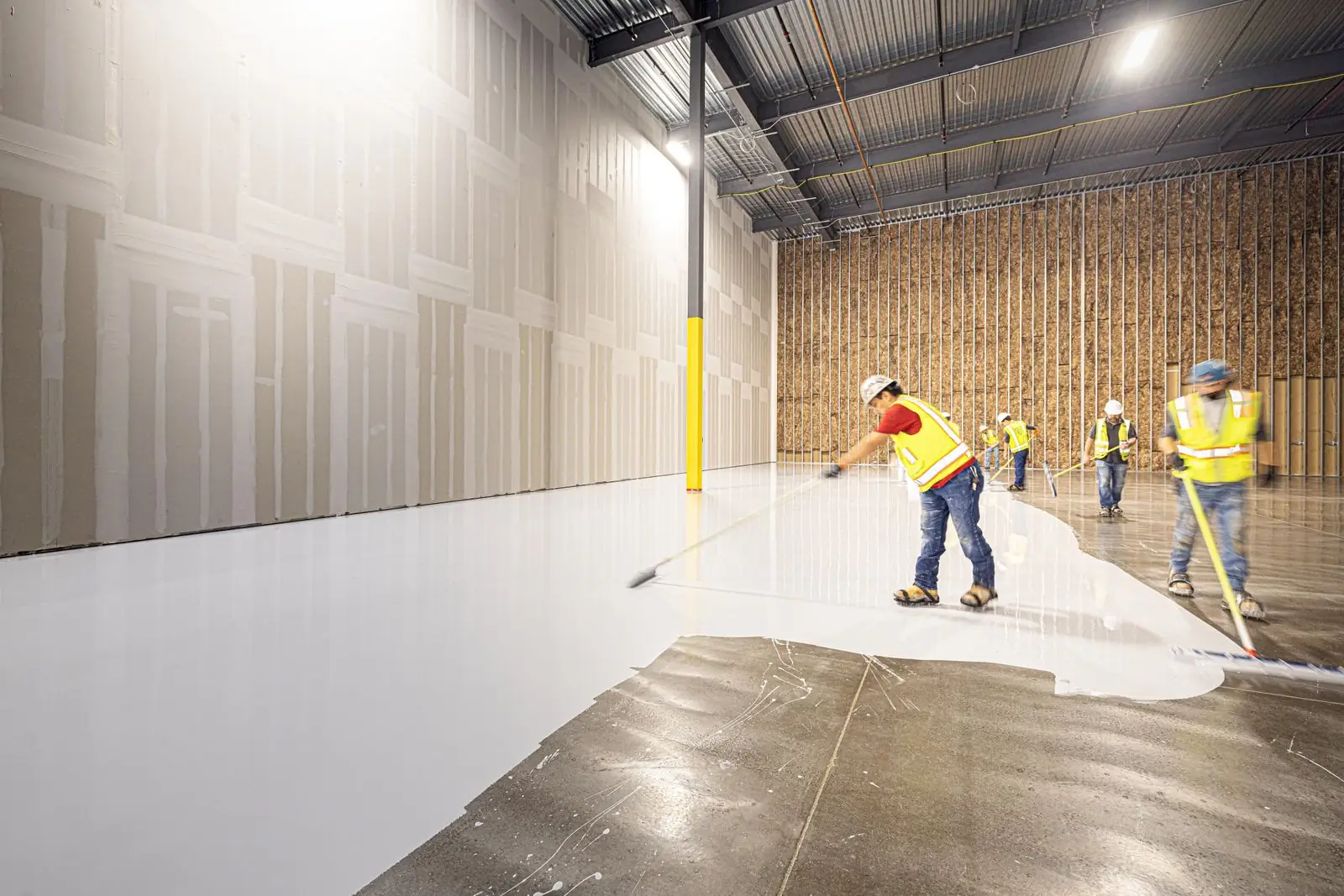 Flooring crew preparing a concrete slab